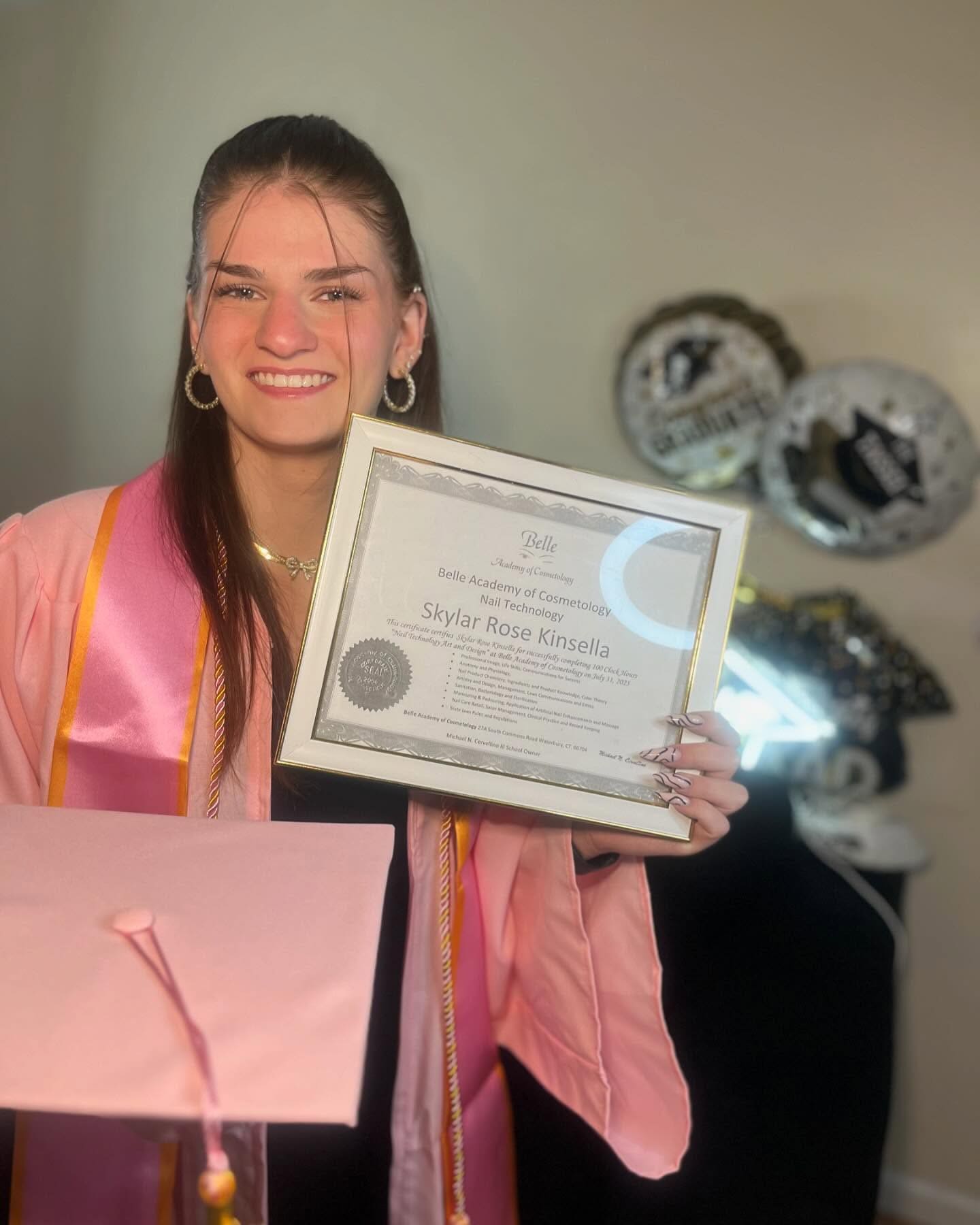 Belle Academy graduate with certificate