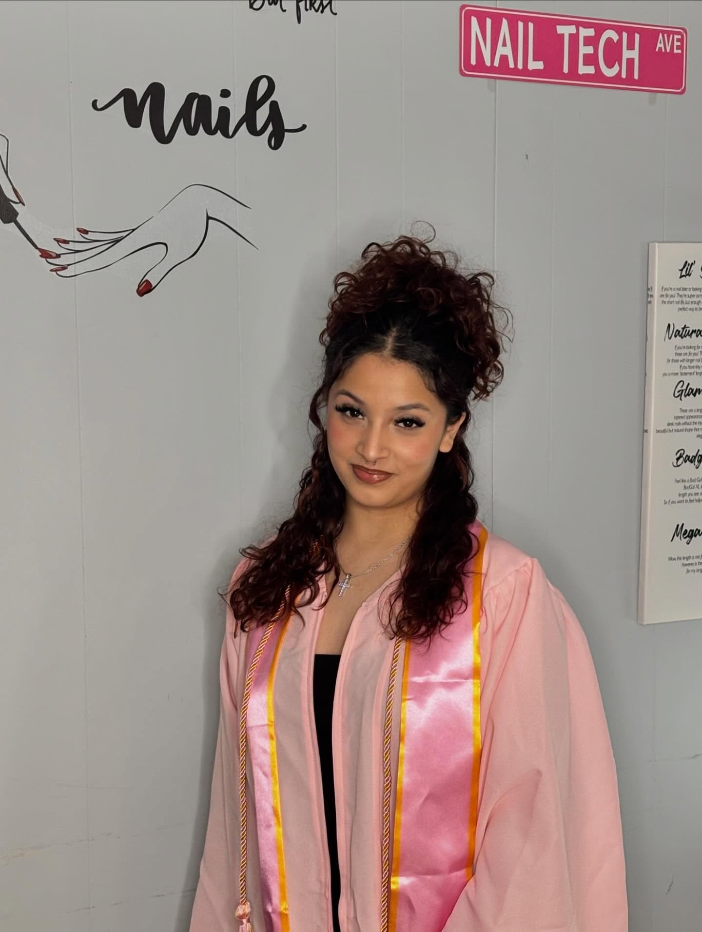Belle Academy graduate portrait in front of Belle Academy wall