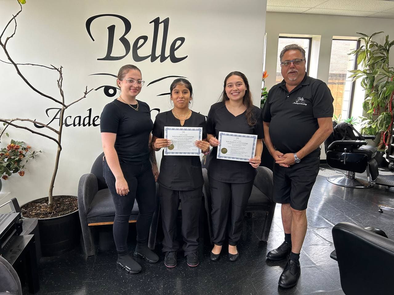 Belle Academy graduates with instructors at Belle Academy